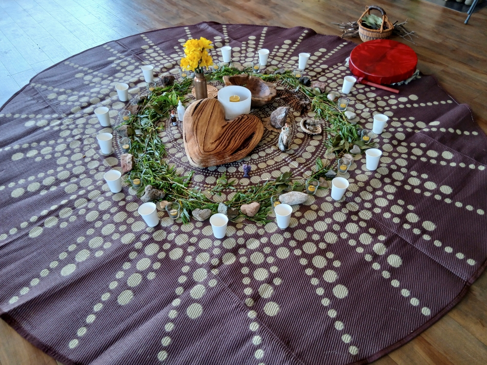A ceremonial altar arranged with candles, flowers and natural objects
